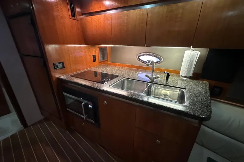 Slide: The Image of Luxurious 2005 Cruisers Yachts 400 Express kitchen with modern amenities and sleek design. - 42