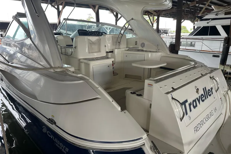 Slide: The Image of 2005 Cruisers Yachts 400 Express docked, showcasing spacious cockpit and elegant design. - 5