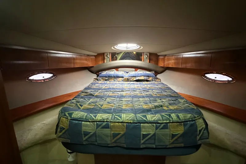 Slide: The Image of Luxurious cabin interior of 2005 Cruisers Yachts 400 Express with cozy bed and porthole windows. - 50