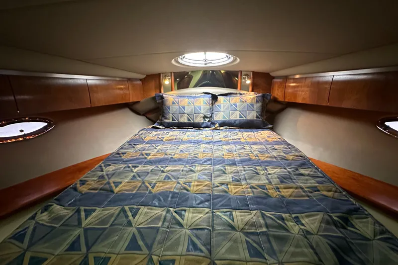Slide: The Image of Luxurious cabin interior of 2005 Cruisers Yachts 400 Express with geometric bedding. - 53