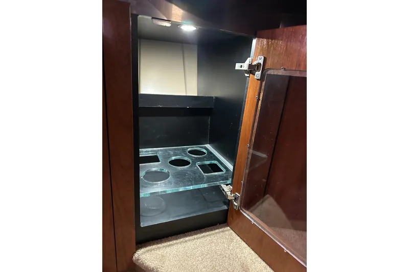 Slide: The Image of Open cabinet with glass shelves in 2005 Cruisers Yachts 400 Express. - 58