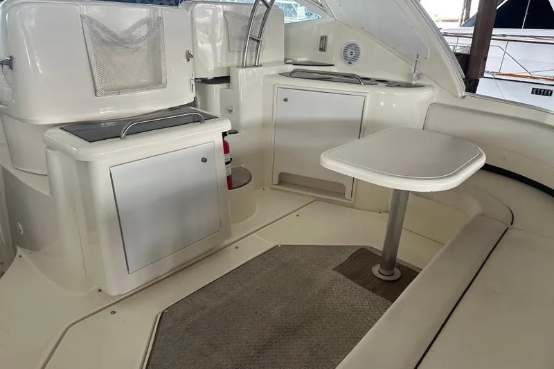 Slide: The Image of 2005 Cruisers Yachts 400 Express interior with seating and table in cabin area. - 7