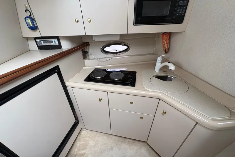 Slide: The Image of 1999 Cruisers Yachts 3375 Esprit galley with stove, sink, and microwave. - 14