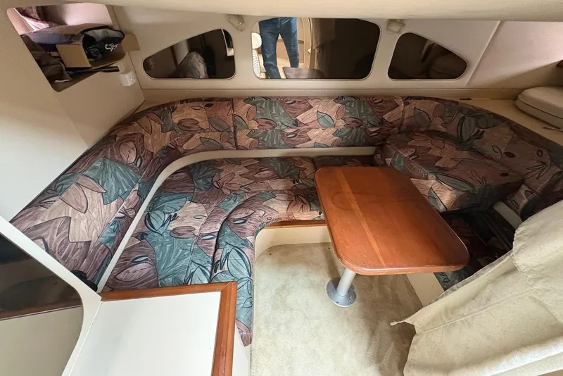 Slide: The Image of 1999 Cruisers Yachts 3375 Esprit cabin interior with patterned seating and wooden table. - 15