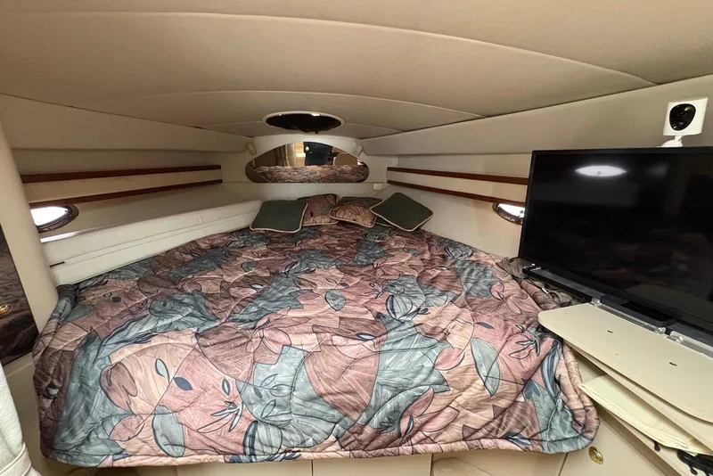 Slide: The Image of Cozy cabin interior of 1999 Cruisers Yachts 3375 Esprit with floral bedding and TV. - 16