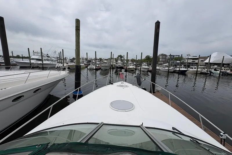 Slide: The Image of 1999 Cruisers Yachts 3375 Esprit docked at a marina with other boats. - 2