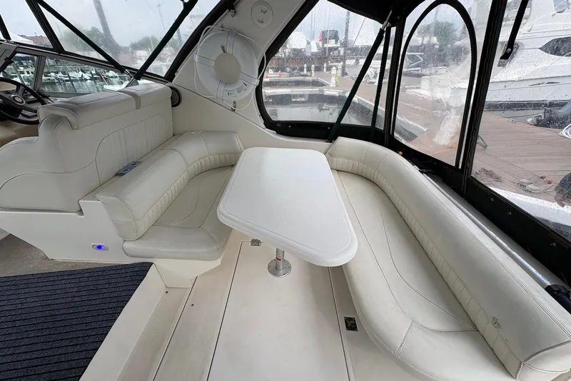 Slide: The Image of 1999 Cruisers Yachts 3375 Esprit interior with white seating and table. - 6
