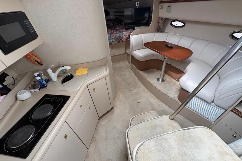 Slide: The Image of Interior of 1999 Cruisers Yachts 3375 Esprit with kitchenette and seating area. - 9