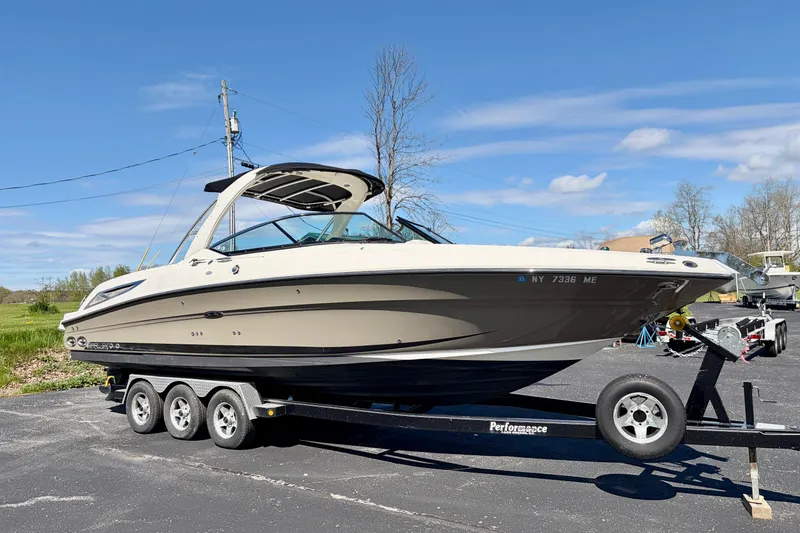 The Image of 2008 Sea Ray 300 SLX boat on trailer under clear blue sky. - 0