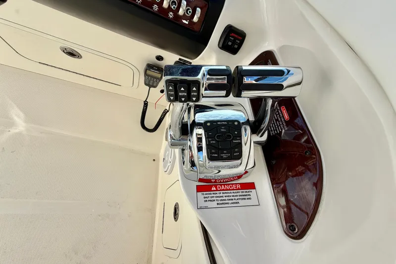 Slide: The Image of Control panel of a 2008 Sea Ray 300 SLX boat with throttle and warning label. - 11