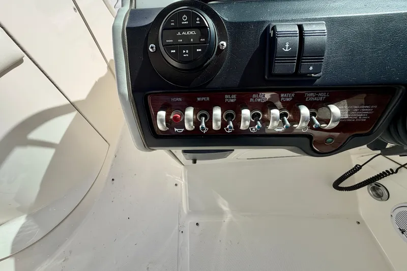 Slide: The Image of Control panel of a 2008 Sea Ray 300 SLX boat with switches and audio system. - 16