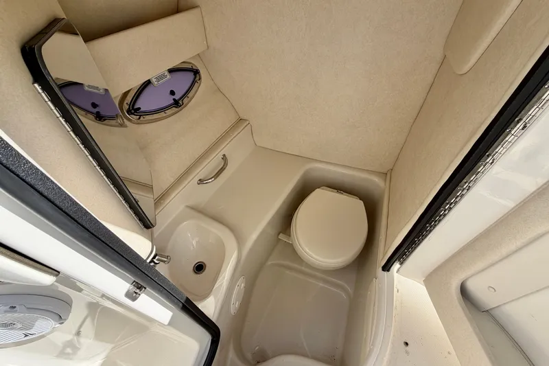 Slide: The Image of Interior of 2008 Sea Ray 300 SLX boat bathroom with toilet and sink. - 19