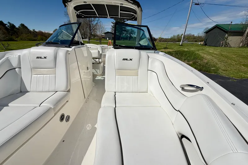 Slide: The Image of 2008 Sea Ray 300 SLX boat interior with white leather seating and open cockpit. - 23