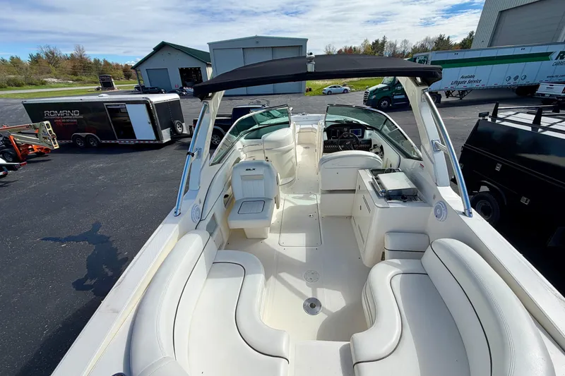 Slide: The Image of 2008 Sea Ray 300 SLX boat with spacious seating and sleek design in a marina setting. - 3