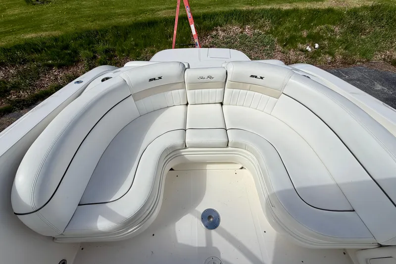 Slide: The Image of 2008 Sea Ray 300 SLX boat with white cushioned seating, outdoor setting. - 4
