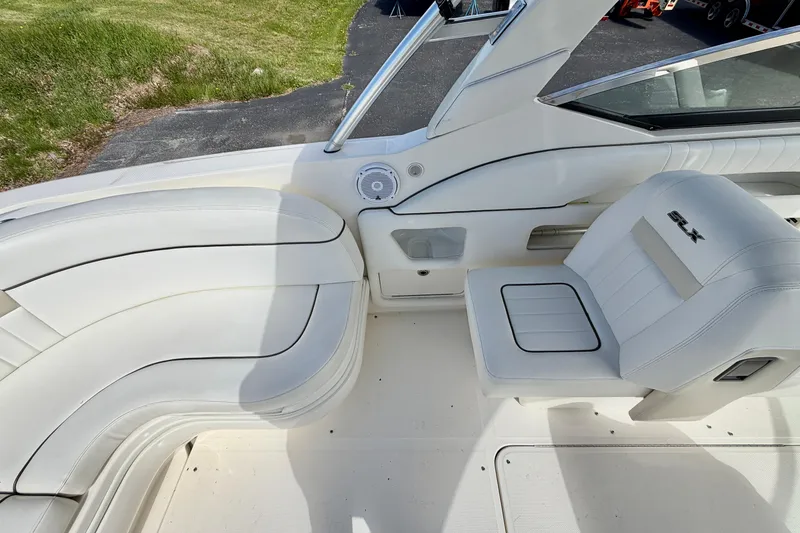 Slide: The Image of 2008 Sea Ray 300 SLX boat interior with white seating and speaker detail. - 5