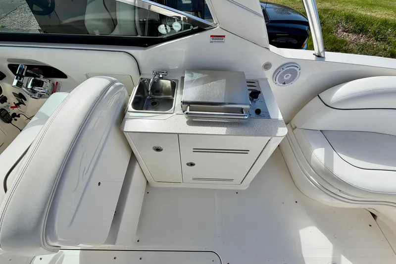 Slide: The Image of Interior view of a 2008 Sea Ray 300 SLX boat featuring a compact kitchenette. - 6