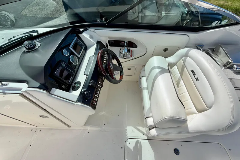 Slide: The Image of 2008 Sea Ray 300 SLX boat cockpit with white leather seating and control panel. - 8