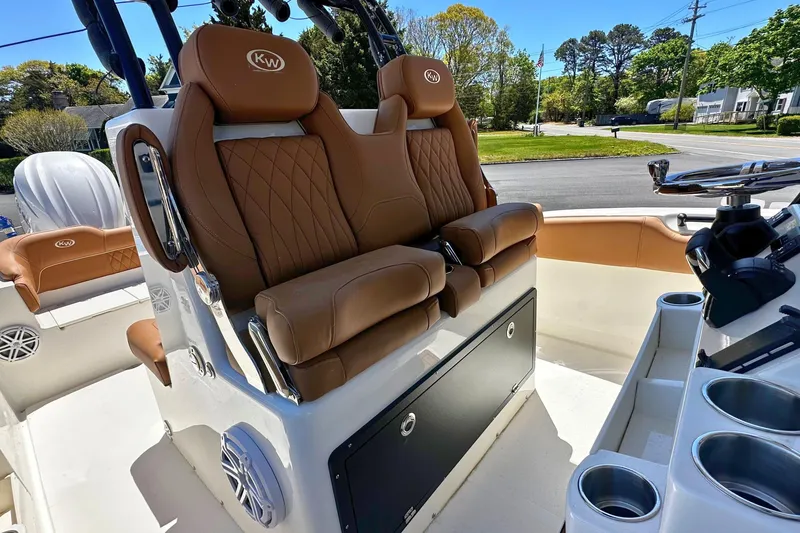 Slide: The Image of 2026 Key West 291 FS boat interior with brown leather seating and cup holders. - 11