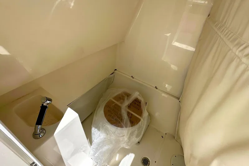 Slide: The Image of Interior of 2026 Key West 291 FS boat bathroom with sink and covered toilet. - 16