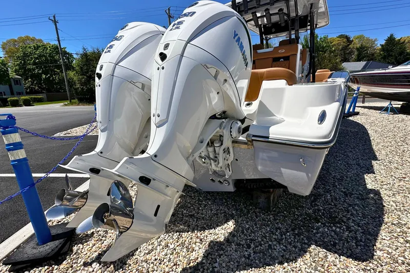 Slide: The Image of 2026 Key West 291 FS boat with dual Yamaha outboard engines displayed on gravel. - 2
