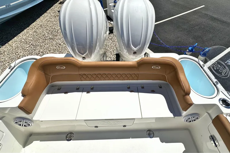 Slide: The Image of 2026 Key West 291 FS boat interior with tan seating and dual engines. - 4