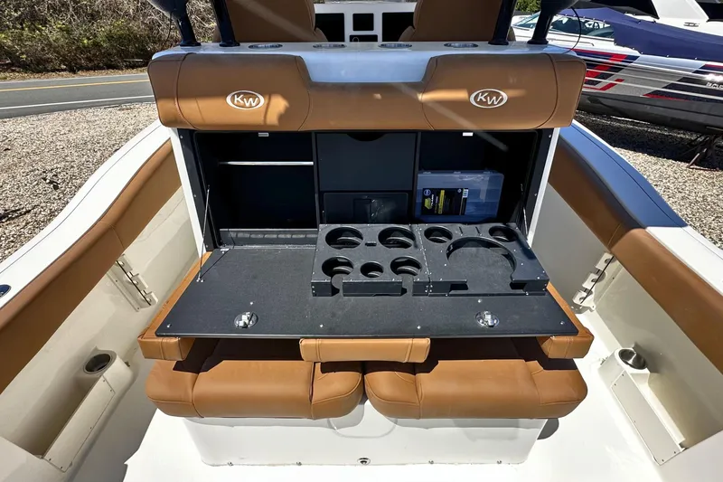 Slide: The Image of 2026 Key West 291 FS boat interior with brown seating and cup holders. - 8