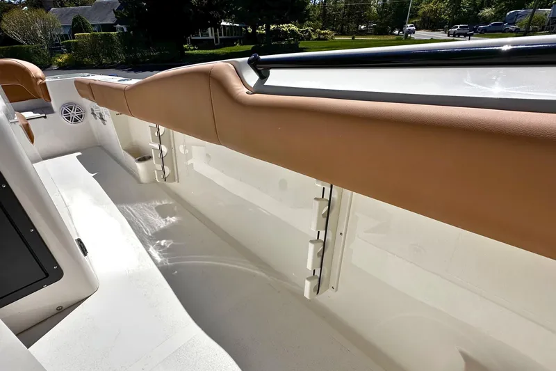Slide: The Image of 2026 Key West 291 FS boat interior with tan seating and white deck. - 9
