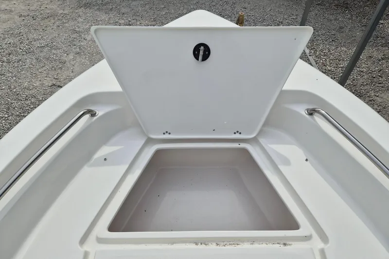 Slide: The Image of Open storage compartment on 2026 Key West 189 FS boat, featuring stainless steel rails. - 14
