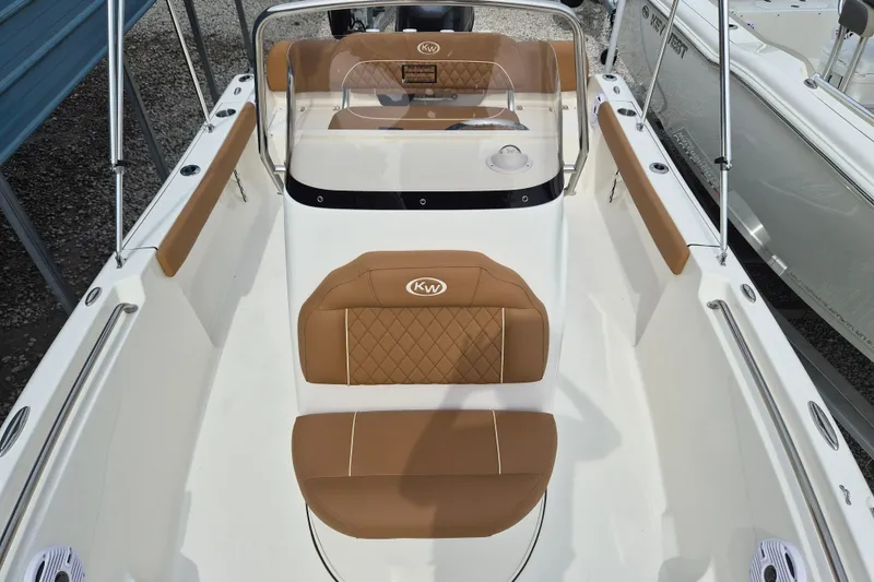 Slide: The Image of 2026 Key West 189 FS boat interior with tan seating and sleek design. - 16