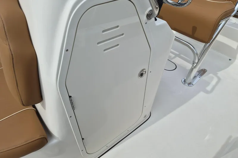 Slide: The Image of 2026 Key West 189 FS boat interior with brown seating and white storage compartment. - 17