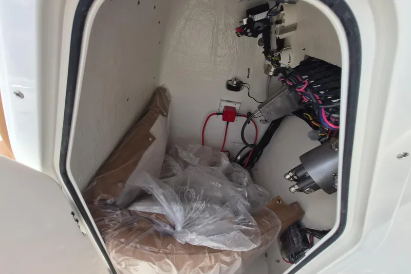 Slide: The Image of Interior view of 2026 Key West 189 FS boat compartment with wiring and equipment. - 18