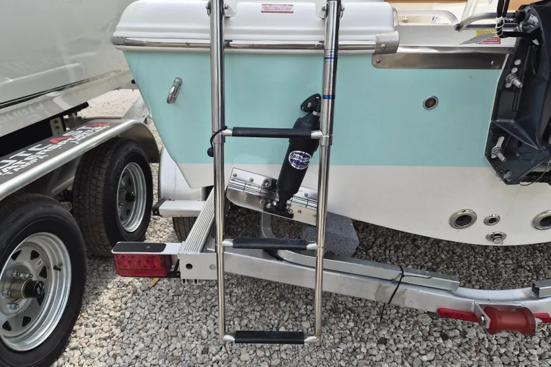 Slide: The Image of 2026 Key West 189 FS boat on trailer with ladder and outboard motor mount. - 4
