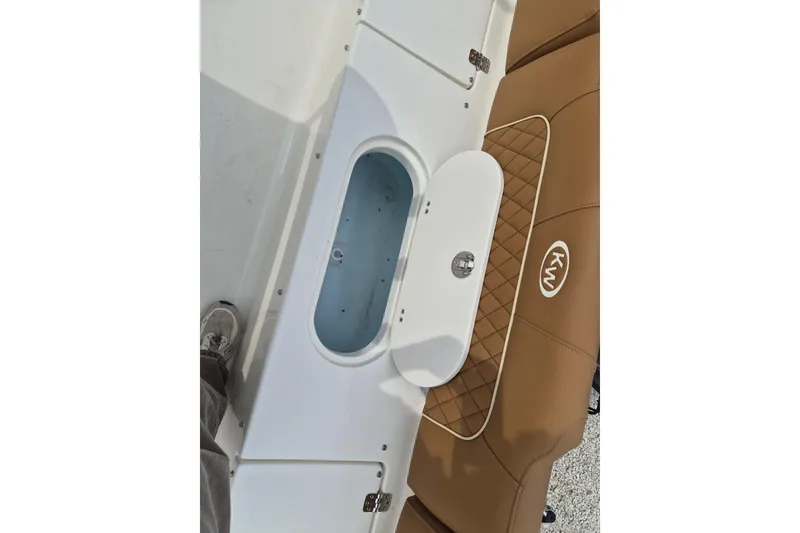 Slide: The Image of 2026 Key West 189 FS boat interior with tan seating and storage compartment. - 7
