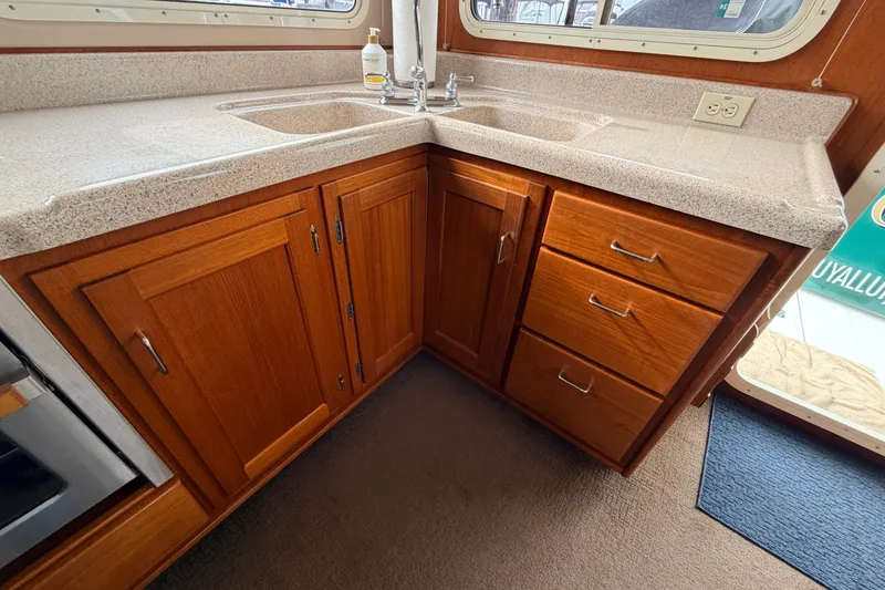 Slide: The Image of Wooden cabinetry and countertop in 2002 American Tug 34 boat interior kitchen. - 15