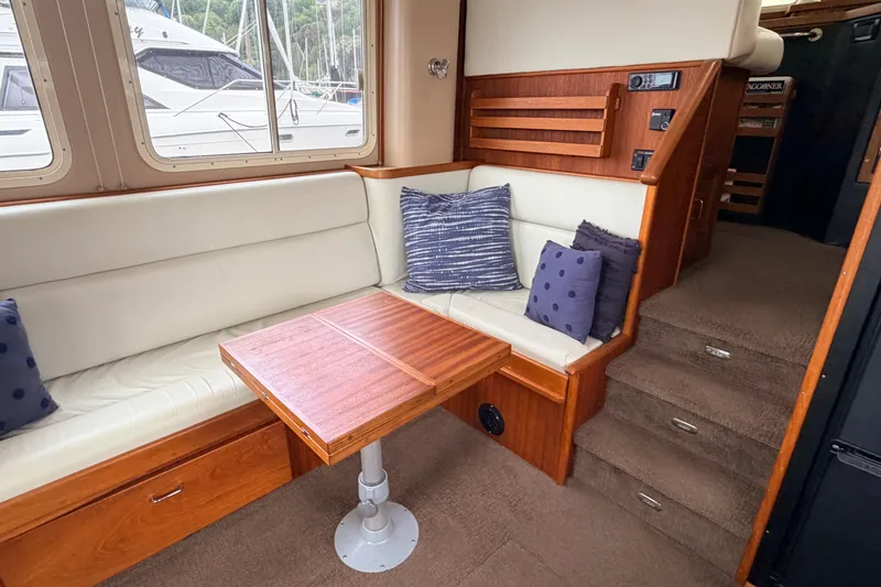 Slide: The Image of Interior of 2002 American Tug 34 with cozy seating and wooden table. - 16