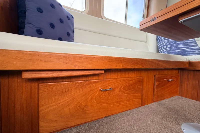 Slide: The Image of Interior of 2002 American Tug 34 with wooden cabinetry and cushioned seating. - 21