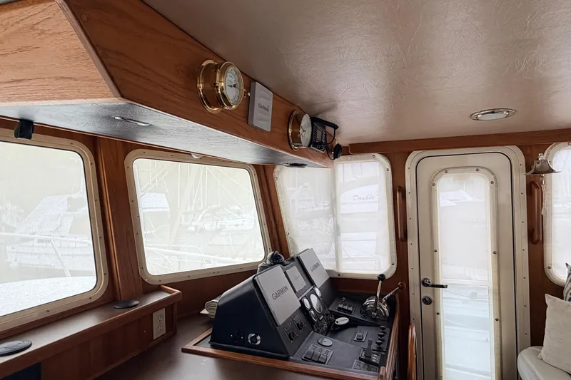 Slide: The Image of Interior helm of 2002 American Tug 34 with navigation equipment and wooden finish. - 27