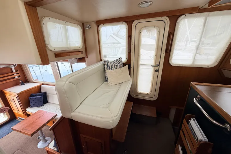 Slide: The Image of Interior of 2002 American Tug 34 with cozy seating and wooden accents. - 30