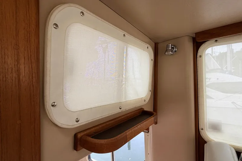 Slide: The Image of Interior of 2002 American Tug 34 with wooden trim and window coverings. - 33