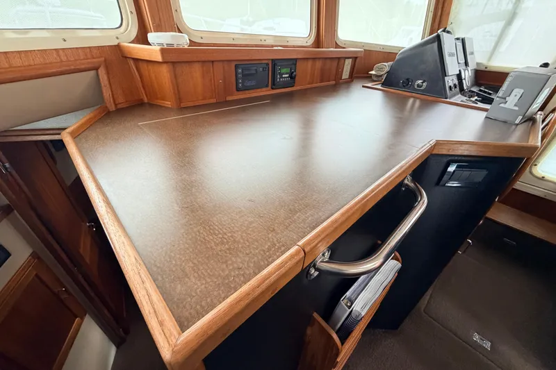 Slide: The Image of Pilothouse interior of 2002 American Tug 34 with wooden cabinetry and navigation equipment. - 38