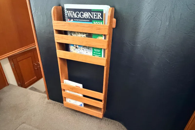 Slide: The Image of Wooden magazine rack on American Tug 34, 2002 model, holding boating guides. - 40