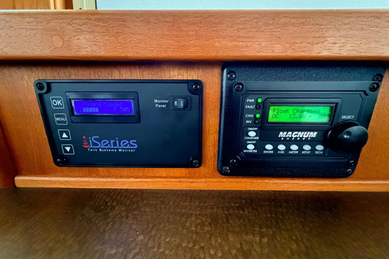 Slide: The Image of Control panels on a 2002 American Tug 34, featuring iSeries and Magnum Energy displays. - 41