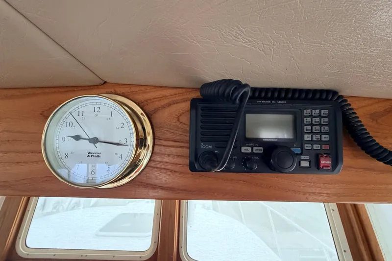 Slide: The Image of Clock and radio equipment inside a 2002 American Tug 34 boat cabin. - 42
