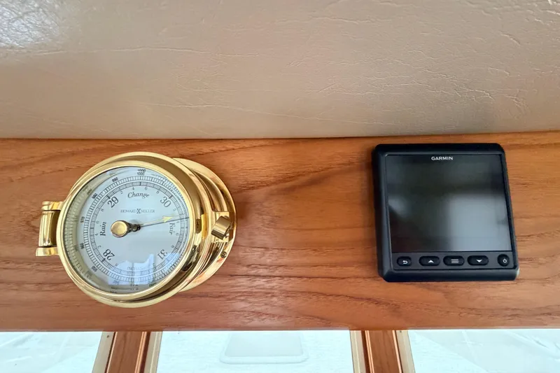 Slide: The Image of Barometer and Garmin device on 2002 American Tug 34 wooden dashboard. - 43