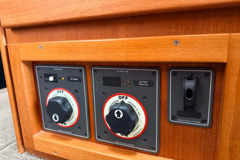 Slide: The Image of Control panel of a 2002 American Tug 34 with switches and dials. - 44