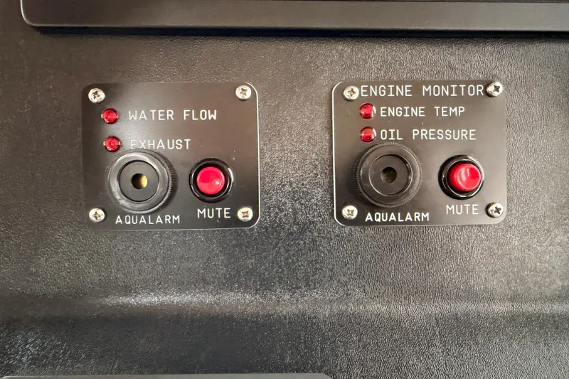 Slide: The Image of Aqualarm control panel on 2002 American Tug 34, featuring water flow and engine monitor indicators. - 47
