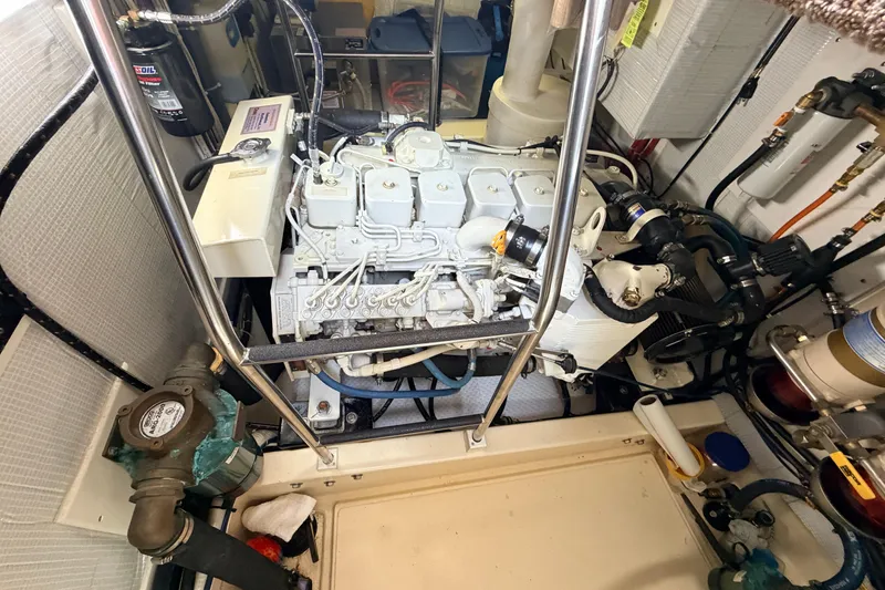 Slide: The Image of Engine room of a 2002 American Tug 34, showcasing mechanical components and piping. - 50