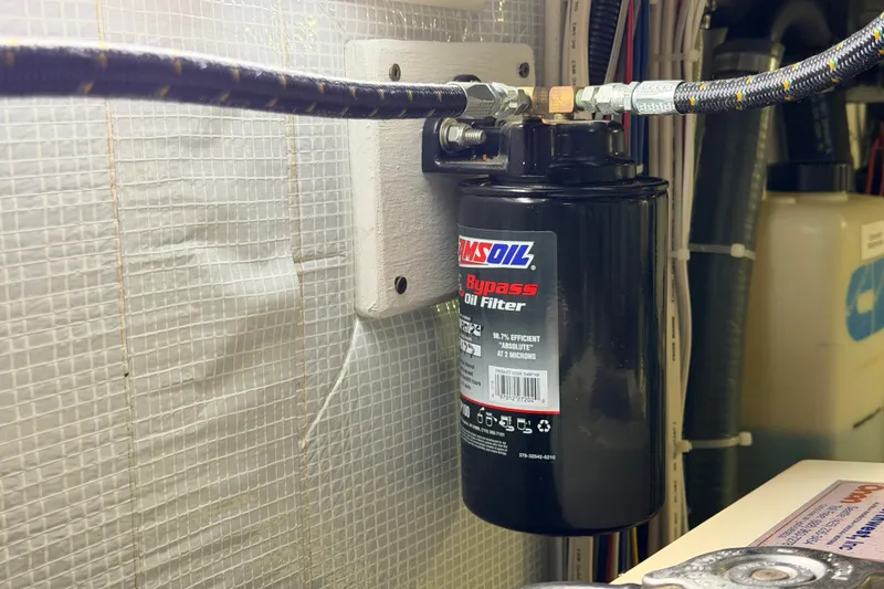 Slide: The Image of AMSOIL bypass oil filter in 2002 American Tug 34 engine room. - 52
