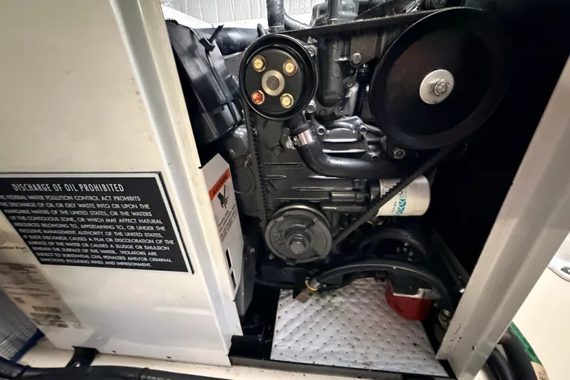 Slide: The Image of Engine compartment of a 2002 American Tug 34, showing belts and components. - 59